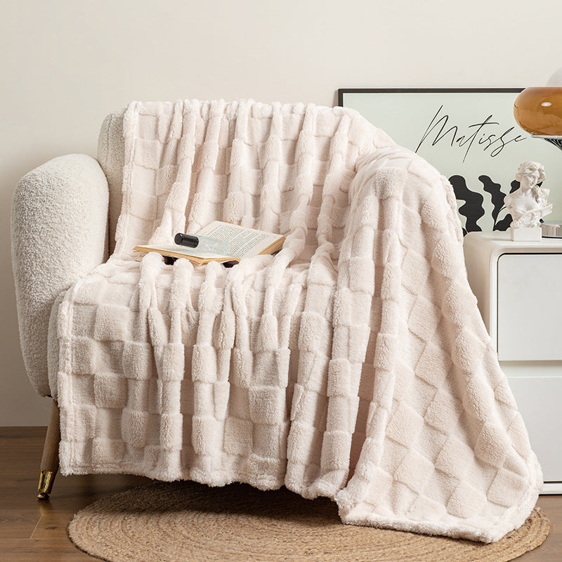 Plaid jacquard cocooning blanc crème posé sur canapé slow living